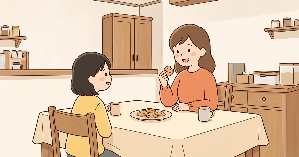 家の台所の食卓で、クッキーの皿をはさんで向かい合うお母さんと女の子